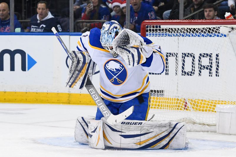 Dec 23, 2023; New York, New York, USA; Buffalo Sabres goaltender Ukko-Pekka Luukkonen (1) takes a puck to the helmet against the New York Rangers during the first period at Madison Square Garden. Mandatory Credit: Dennis Schneidler-USA TODAY Sports