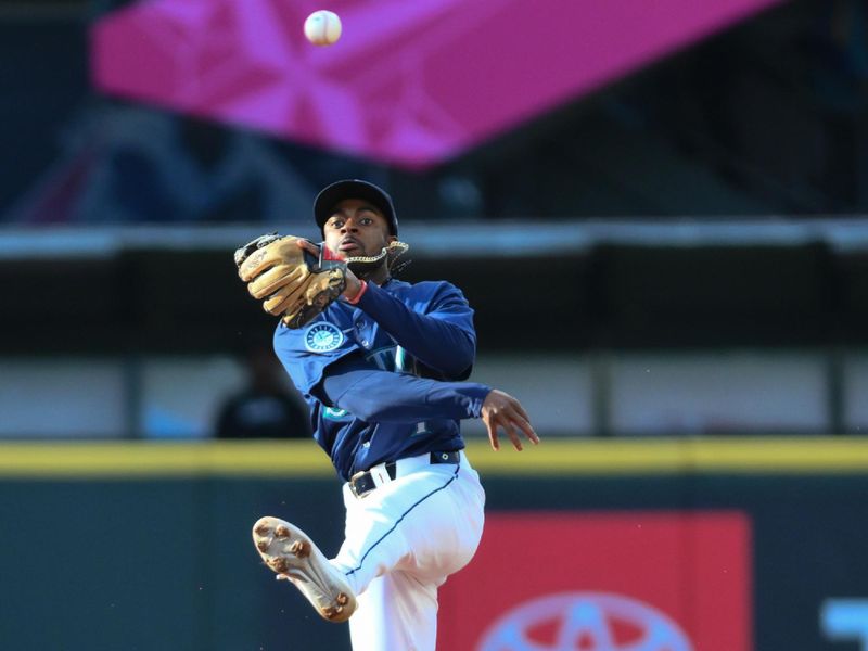 Jun 11, 2024; Seattle, Washington, USA; Seattle Mariners second baseman Ryan Bliss (1) throws the ball to first base during the first inning against the Chicago White Sox at T-Mobile Park. Mandatory Credit: Steven Bisig-USA TODAY Sports