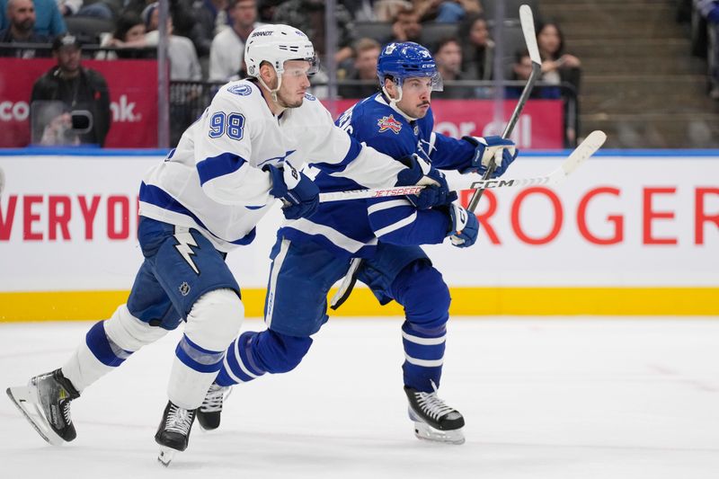 Nov 6, 2023; Toronto, Ontario, CAN; Tampa Bay Lightning defenseman Mikhail Sergachev (98) blocks out Toronto Maple Leafs forward Auston Matthews (34)  during the third period at Scotiabank Arena. Mandatory Credit: John E. Sokolowski-USA TODAY Sports