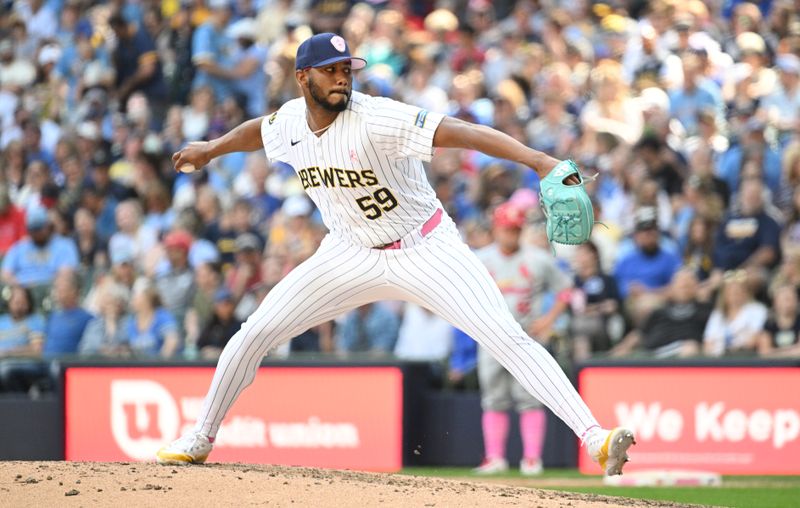 May 12, 2024; Milwaukee, Wisconsin, USA; Milwaukee Brewers pitcher Elvis Peguero (59) delivers a pitch against the St. Louis Cardinals in the seventh inning at American Family Field. Mandatory Credit: Michael McLoone-USA TODAY Sports