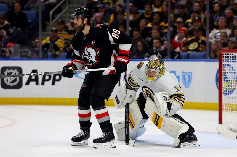 Dec 27, 2023; Buffalo, New York, USA;  Buffalo Sabres right wing Alex Tuch (89) and Boston Bruins goaltender Jeremy Swayman (1) look for the puck during the second period at KeyBank Center. Mandatory Credit: Timothy T. Ludwig-USA TODAY Sports