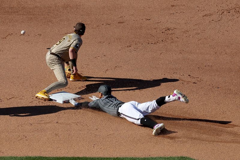 Jun 15, 2024; New York City, New York, USA; New York Mets shortstop Francisco Lindor (12) slides into second for a double ahead of the tag by San Diego Padres second baseman Jake Cronenworth (9) during the fourth inning at Citi Field. Mandatory Credit: Brad Penner-USA TODAY Sports