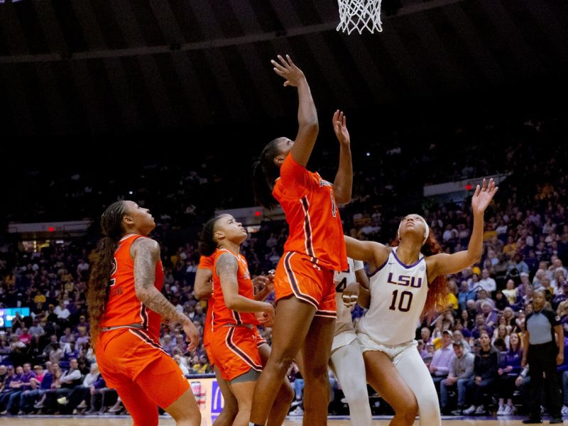 Feb 22, 2024; Baton Rouge, Louisiana, USA;  LSU Lady Tigers guard Mikaylah Williams (12) watches her basket go in after falling to floor from contact with Auburn Tigers forward Taylen Collins (14) during the second half at Pete Maravich Assembly Center. Mandatory Credit: Matthew Hinton-USA TODAY Sports