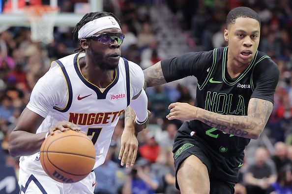 NEW ORLEANS, LOUISIANA - NOVEMBER 17: Reggie Jackson #7 of the Denver Nuggets dribbles the ball against Jordan Hawkins #24 of the New Orleans Pelicans during the first half of an NBA In-Season Tournament game at the Smoothie King Center on November 17, 2023 in New Orleans, Louisiana. NOTE TO USER: User expressly acknowledges and agrees that, by downloading and or using this Photograph, user is consenting to the terms and conditions of the Getty Images License Agreement. (Photo by Jonathan Bachman/Getty Images)