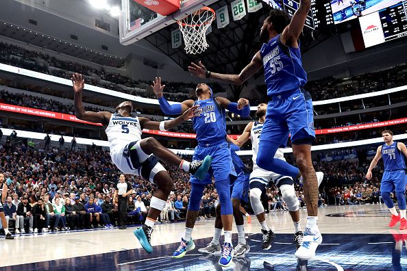 DALLAS, TEXAS - DECEMBER 14: Anthony Edwards #5 of the Minnesota Timberwolves shoots the ball against Richaun Holmes #20 of the Dallas Mavericks  and Derrick Jones Jr. #55 of the Dallas Mavericks in the first half at American Airlines Center on December 14, 2023 in Dallas, Texas. NOTE TO USER: User expressly acknowledges and agrees that, by downloading and or using this photograph, User is consenting to the terms and conditions of the Getty Images License Agreement. (Photo by Tim Heitman/Getty Images)