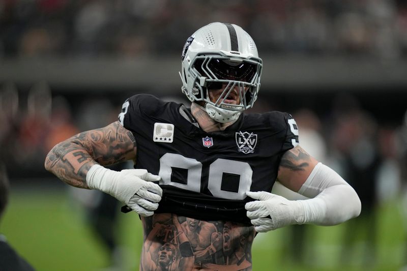 Las Vegas Raiders defensive end Maxx Crosby warms up before an NFL football game between the Kansas City Chiefs and Las Vegas Raiders Sunday, Oct. 27, 2024, in Las Vegas. (AP Photo/John Locher)