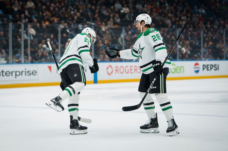 Nov 20, 2025; Vancouver, British Columbia, CAN; Dallas Stars forward Jason Robertson (21) and defenseman Alexander Petrovic (28) celebrate Robertson’s goal against the Vancouver Canucks in the first period at Rogers Arena. Mandatory Credit: Bob Frid-Imagn Images