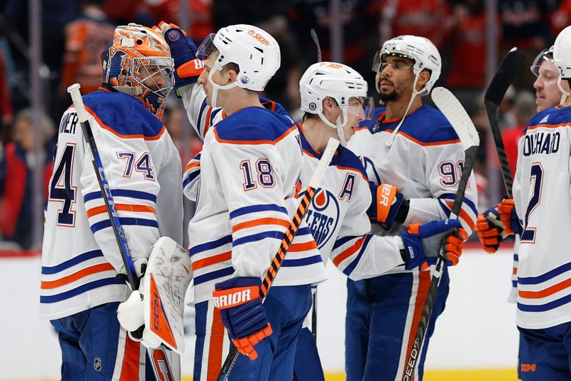 Nov 24, 2023; Washington, District of Columbia, USA; Edmonton Oilers goaltender Stuart Skinner (74) celebrates with Oilers left wing Zach Hyman (18) after thei game against the Washington Capitals at Capital One Arena. Mandatory Credit: Geoff Burke-USA TODAY Sports