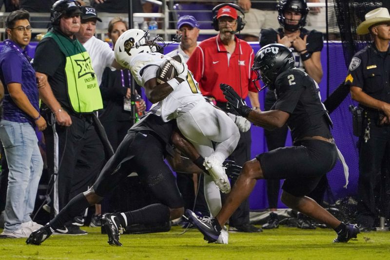Oct 4, 2025; Fort Worth, Texas, USA; Colorado Buffaloes wide receiver Quentin Gibson (15) is tackled by. TCU Horned Frogs safety Bud Clark (21) and TCU Horned Frogs safety Jamel Johnson (2) during the first half at Amon G. Carter Stadium. Mandatory Credit: Raymond Carlin III-Imagn Images