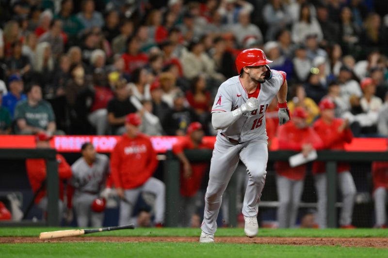 Sep 11, 2023; Seattle, Washington, USA; Los Angeles Angels left fielder Randal Grichuk (15) runs towards first base after hitting an RBI single against the Seattle Mariners during the eleventh inning at T-Mobile Park. Mandatory Credit: Steven Bisig-USA TODAY Sports