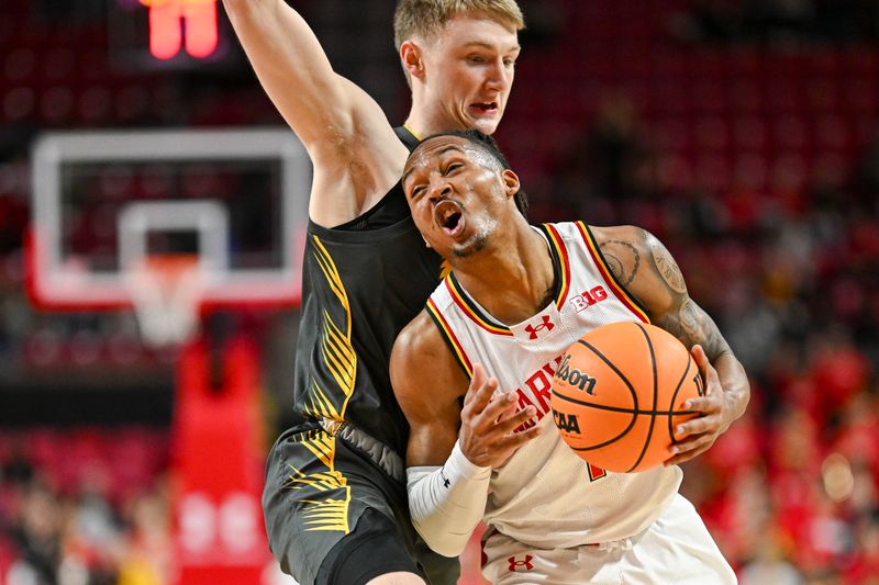 Feb 14, 2024; College Park, Maryland, USA;  Maryland Terrapins guard Jahmir Young (1) reacts as Iowa Hawkeyes guard Josh Dix (4) defends during the second half at Xfinity Center. Mandatory Credit: Tommy Gilligan-USA TODAY Sports