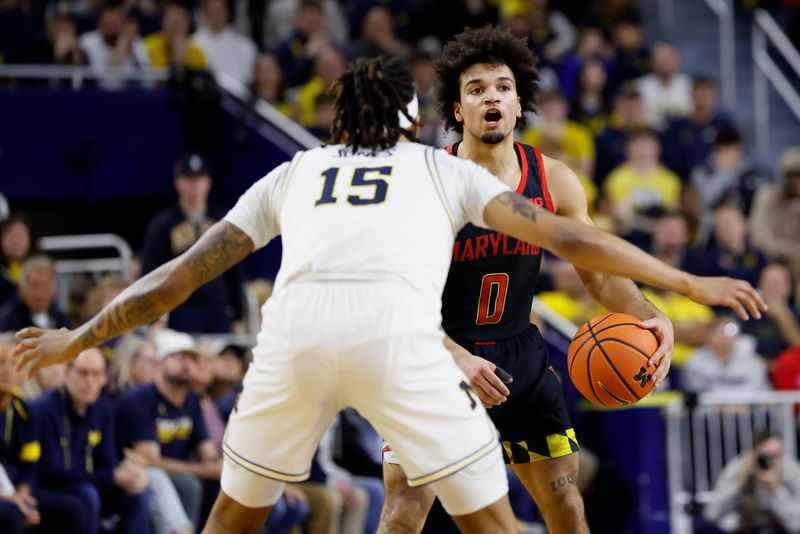 Mar 5, 2025; Ann Arbor, Michigan, USA;  Maryland Terrapins Donald Carey (0) dribbles defended by Michigan Wolverines guard Rubin Jones (15) in the second half at Crisler Center. Mandatory Credit: Rick Osentoski-Imagn Images