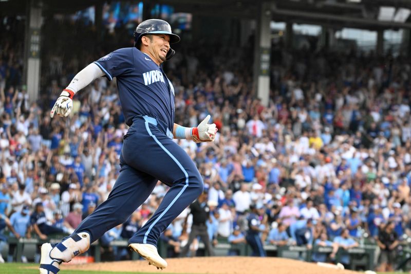 Aug 16, 2024; Chicago, Illinois, USA;  Chicago Cubs outfielder Seiya Suzuki (27) rounds first base after hitting the game winning RBI single against the Toronto Blue Jays during the tenth inning at Wrigley Field. Mandatory Credit: Matt Marton-USA TODAY Sports