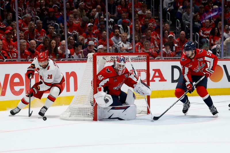 May 15, 2025; Washington, District of Columbia, USA; Carolina Hurricanes left wing William Carrier (28) prepares to shoot the puck on Washington Capitals goaltender Logan Thompson (48) as Capitals defenseman Trevor van Riemsdyk (57) defends in the second period in game five of the second round of the 2025 Stanley Cup Playoffs at Capital One Arena. Mandatory Credit: Geoff Burke-Imagn Images