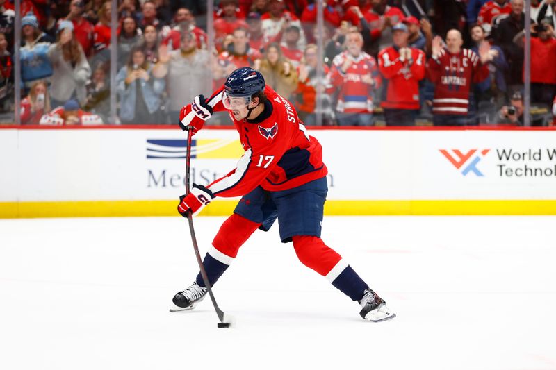 Mar 22, 2024; Washington, District of Columbia, USA; Washington Capitals center Dylan Strome (17) shoots the puck to score the game winning goal during a shootout against the Carolina Hurricanes at Capital One Arena. Mandatory Credit: Amber Searls-USA TODAY Sports