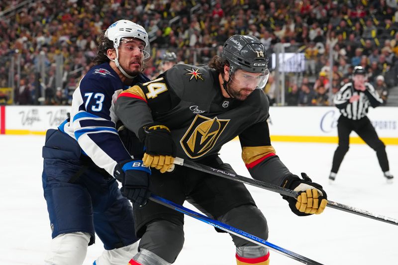 Apr 3, 2025; Las Vegas, Nevada, USA; Vegas Golden Knights defenseman Nicolas Hague (14) battles Winnipeg Jets left wing Brandon Tanev (73) for position during the first period at T-Mobile Arena. Mandatory Credit: Stephen R. Sylvanie-Imagn Images