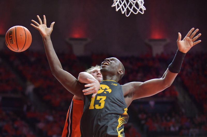 Feb 25, 2025; Champaign, Illinois, USA;  Illinois Fighting Illini forward Jake Davis (15) fouls Iowa Hawkeyes forward Ladji Dembele (13) during the second half at State Farm Center. Mandatory Credit: Ron Johnson-Imagn Images