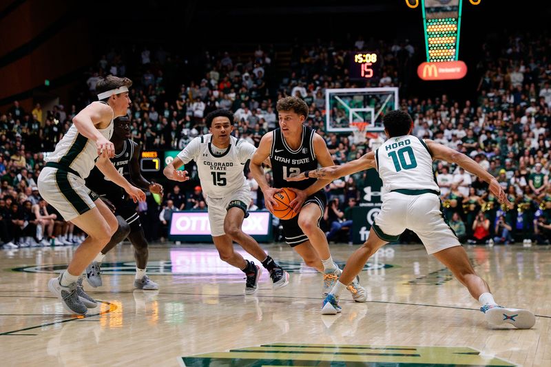 Feb 17, 2024; Fort Collins, Colorado, USA; Utah State Aggies guard Mason Falslev (12) controls the ball against Colorado State Rams guard Jalen Lake (15) and guard Nique Clifford (10) as guard Joe Palmer (20) and forward Kalifa Sakho (34) defend in the first half at Moby Arena. Mandatory Credit: Isaiah J. Downing-USA TODAY Sports