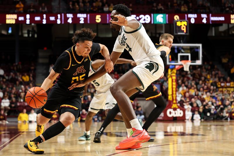 Dec 4, 2024; Minneapolis, Minnesota, USA; Minnesota Golden Gophers guard Lu'Cye Patterson (25) works around Michigan State Spartans forward Xavier Booker (34) during the first half at Williams Arena. Mandatory Credit: Matt Krohn-Imagn Images