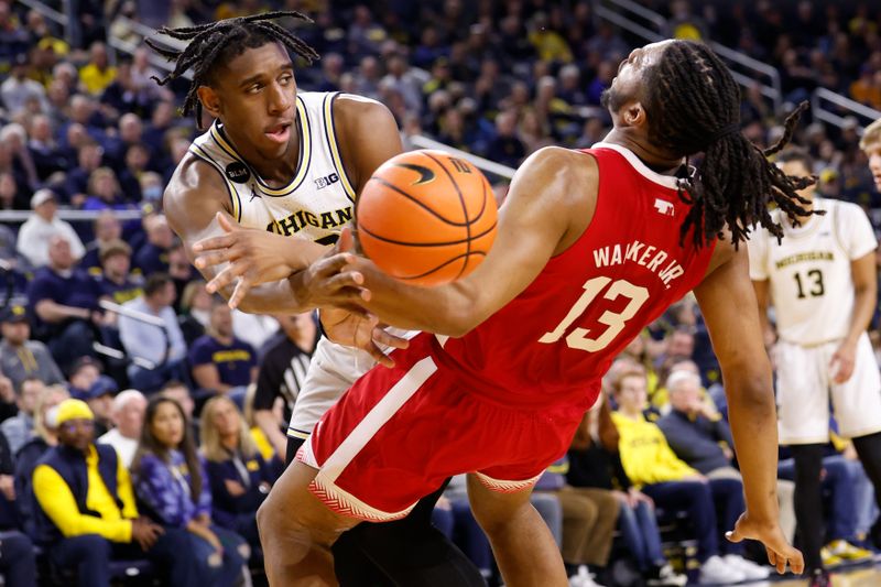 Feb 8, 2023; Ann Arbor, Michigan, USA;  Nebraska Cornhuskers forward Derrick Walker (13) is fouled by Michigan Wolverines forward Tarris Reed Jr. (32) in the first half at Crisler Center. Mandatory Credit: Rick Osentoski-USA TODAY Sports