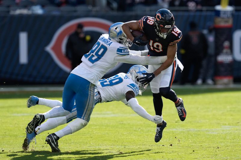 Chicago Bears wide receiver Equanimeous St. Brown (19) is tackled by Detroit Lions linebacker Julian Okwara (99) and cornerback Jerry Jacobs (39) during the second half of an NFL football game in Chicago, Sunday, Nov. 13, 2022. (AP Photo/Charles Rex Arbogast)