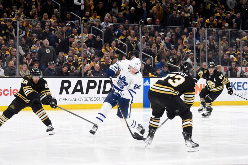 Apr 30, 2024; Boston, Massachusetts, USA; Toronto Maple Leafs center David Kampf (64) shoots the puck between Boston Bruins defenseman Matt Grzelcyk (48) and defenseman Charlie McAvoy (73) during overtime in game five of the first round of the 2024 Stanley Cup Playoffs at TD Garden. Mandatory Credit: Bob DeChiara-USA TODAY Sports