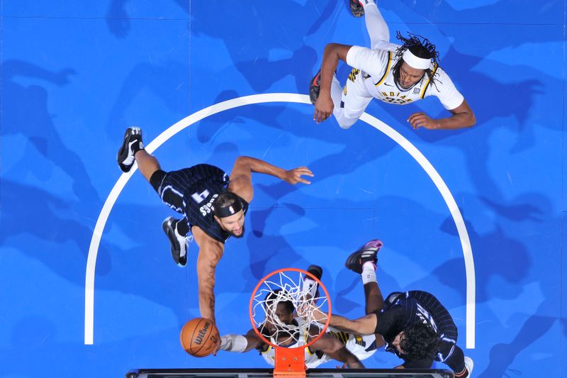 ORLANDO, FL - NOVEMBER 13: Jalen Suggs #4 of the Orlando Magic blocks the shot during the game against the Indiana Pacers  on November 13, 2024 at Kia Center in Orlando, Florida. NOTE TO USER: User expressly acknowledges and agrees that, by downloading and or using this photograph, User is consenting to the terms and conditions of the Getty Images License Agreement. Mandatory Copyright Notice: Copyright 2024 NBAE (Photo by Fernando Medina/NBAE via Getty Images)