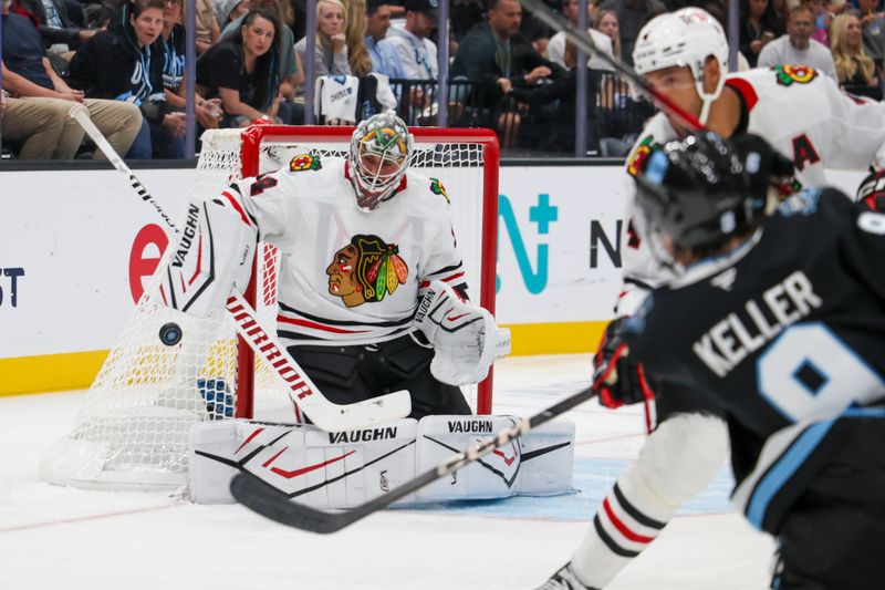 Oct 8, 2024; Salt Lake City, Utah, USA; Chicago Blackhawks goaltender Petr Mrazek (34) blocks a shot by Utah Hockey Club forward Clayton Keller (9) during the second period at Delta Center. Mandatory Credit: Rob Gray-Imagn Images