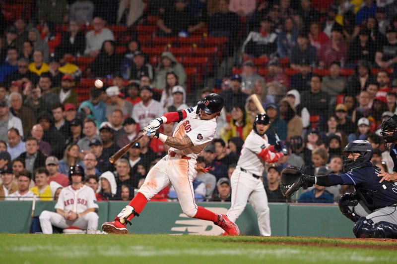 May 15, 2024; Boston, Massachusetts, USA; Boston Red Sox center fielder Jarren Duran (16) hits a double against the Tampa Bay Rays during the seventh inning at Fenway Park. Mandatory Credit: Eric Canha-USA TODAY Sports