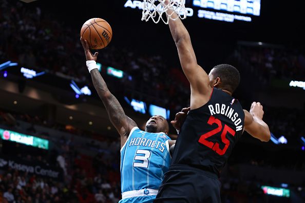 MIAMI, FLORIDA - DECEMBER 13: Terry Rozier #3 of the Charlotte Hornets shoots the ball against Orlando Robinson #25 of the Miami Heat during the third quarter of the game at Kaseya Center on December 13, 2023 in Miami, Florida. NOTE TO USER: User expressly acknowledges and agrees that, by downloading and or using this photograph, User is consenting to the terms and conditions of the Getty Images License Agreement. (Photo by Megan Briggs/Getty Images)