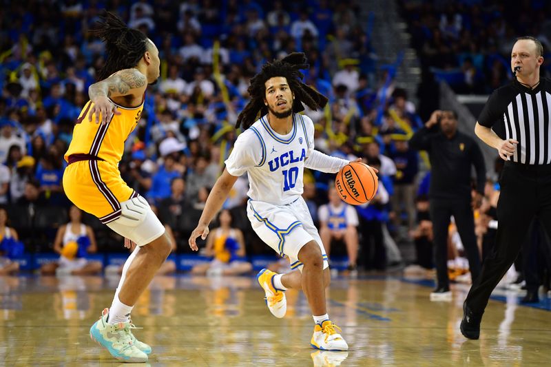 Mar 2, 2023; Los Angeles, California, USA; UCLA Bruins guard Tyger Campbell (10) moves the ball against Arizona State Sun Devils guard Frankie Collins (10) during the second half at Pauley Pavilion. Mandatory Credit: Gary A. Vasquez-USA TODAY Sports