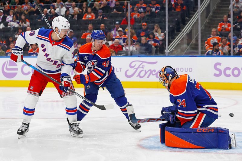 Nov 23, 2024; Edmonton, Alberta, CAN; New York Rangers forward Chris Kreider (20) deflects a shot wide of Edmonton Oilers goaltender Stuart Skinner (74) during the second period at Rogers Place. Mandatory Credit: Perry Nelson-Imagn Images