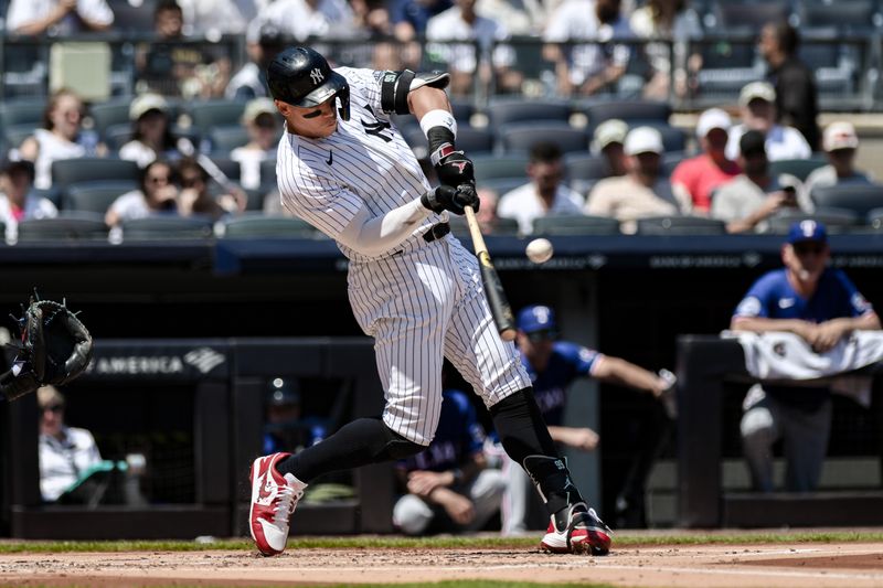 Aug 10, 2024; Bronx, New York, USA; New York Yankees outfielder Aaron Judge (99) hits a single against the Texas Rangers during the first inning at Yankee Stadium. Mandatory Credit: John Jones-USA TODAY Sports