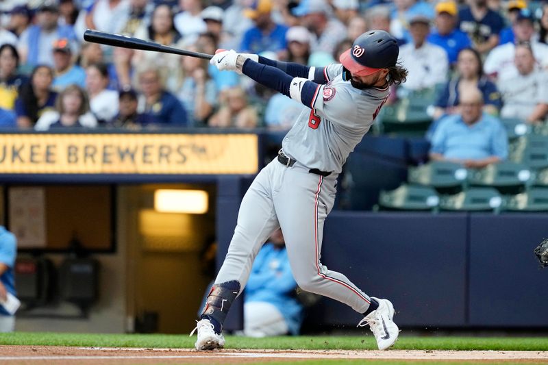 Jul 12, 2024; Milwaukee, Wisconsin, USA;  Washington Nationals designated hitter Jesse Winker (6) hits an RBI double during the first inning against the Milwaukee Brewers at American Family Field. Mandatory Credit: Jeff Hanisch-USA TODAY Sports