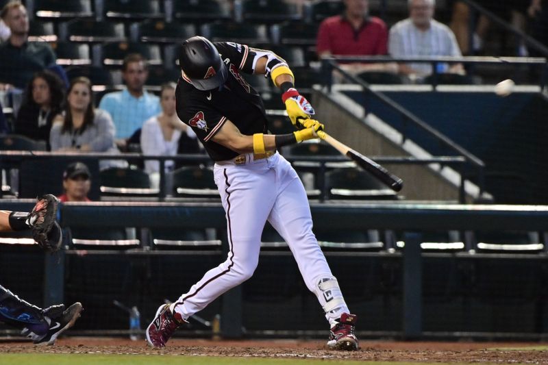 Sep 6, 2023; Phoenix, Arizona, USA; Arizona Diamondbacks left fielder Lourdes Gurriel Jr. (12) hits an RBI single in the sixth inning against the Colorado Rockies at Chase Field. Mandatory Credit: Matt Kartozian-USA TODAY Sports