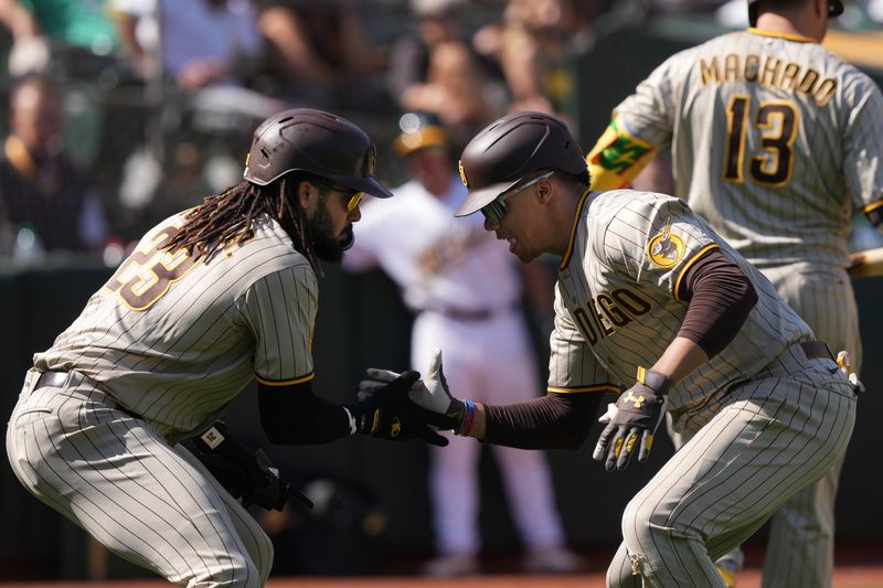 Sep 17, 2023; Oakland, California, USA; San Diego Padres left fielder Juan Soto (right) celebrates with right fielder Fernando Tatis Jr. (23) after hitting a home run against the Oakland Athletics during the seventh inning at Oakland-Alameda County Coliseum. Mandatory Credit: Darren Yamashita-USA TODAY Sports