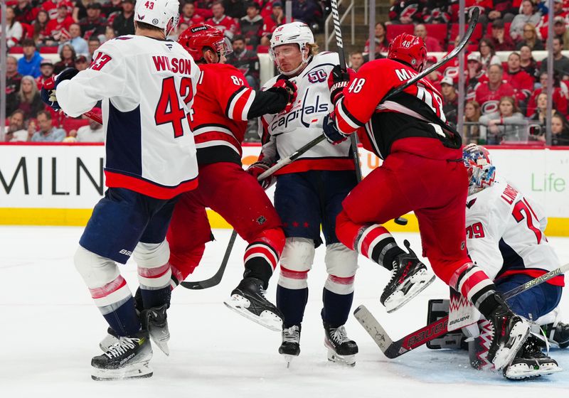 Apr 2, 2025; Raleigh, North Carolina, USA;  Washington Capitals defenseman Rasmus Sandin (38) Carolina Hurricanes center Jesperi Kotkaniemi (82) and left wing Jordan Martinook (48) watch a shot during the third period at Lenovo Center. Mandatory Credit: James Guillory-Imagn Images
