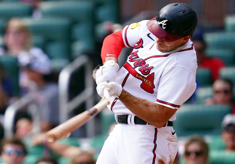 Sep 10, 2023; Cumberland, Georgia, USA; Atlanta Braves first baseman Matt Olson (28) breaks his bat against the Pittsburgh Pirates during the sixth inning at Truist Park. Mandatory Credit: John David Mercer-USA TODAY Sports