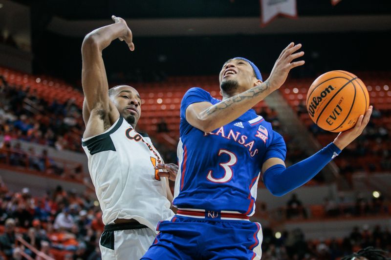 Jan 16, 2024; Stillwater, Oklahoma, USA; Kansas Jayhawks guard Dajuan Harris Jr. (3) puts up a shot around Oklahoma State Cowboys guard Bryce Thompson (1) during the second half at Gallagher-Iba Arena. Mandatory Credit: William Purnell-USA TODAY Sports