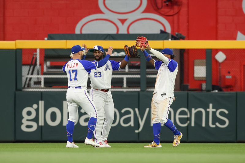 May 6, 2023; Atlanta, Georgia, USA; Atlanta Braves left fielder Kevin Pillar (17) and center fielder Michael Harris II (23) and right fielder Ronald Acuna Jr. (13) celebrate after a victory against the Baltimore Orioles at Truist Park. Mandatory Credit: Brett Davis-USA TODAY Sports