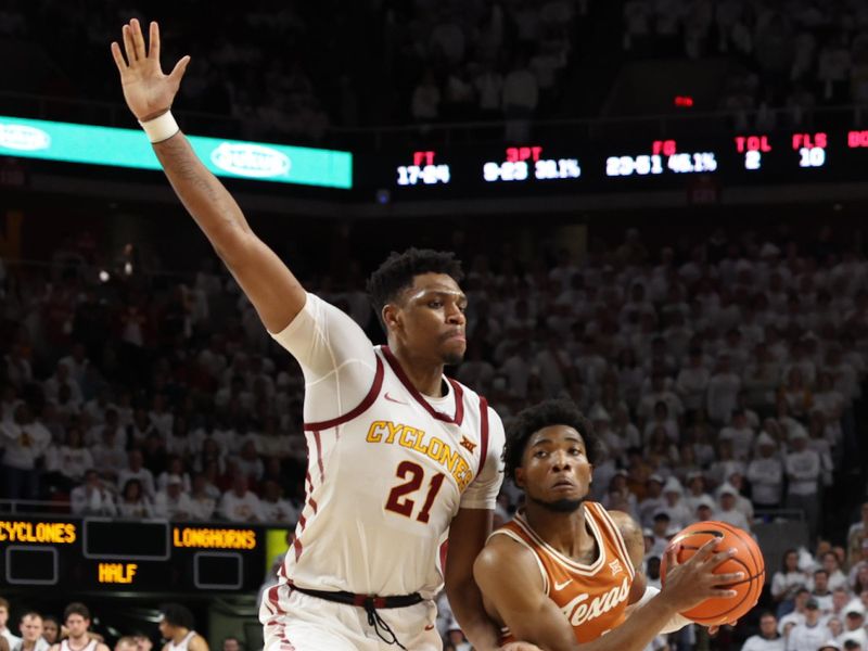 Jan 17, 2023; Ames, Iowa, USA; Iowa State Cyclones center Osun Osunniyi (21) defends Texas Longhorns guard Tyrese Hunter (right) during the second half at James H. Hilton Coliseum. Mandatory Credit: Reese Strickland-USA TODAY Sports