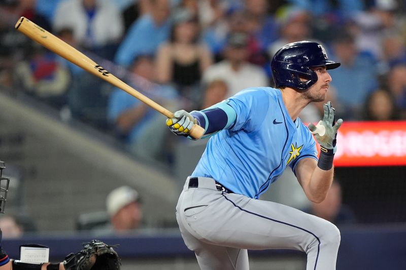 Sep 26, 2025; Toronto, Ontario, CAN; Tampa Bay Rays right fielder Joshua Lowe (15) hits a single against the Toronto Blue Jays during the fourth inning at Rogers Centre. Mandatory Credit: John E. Sokolowski-Imagn Images