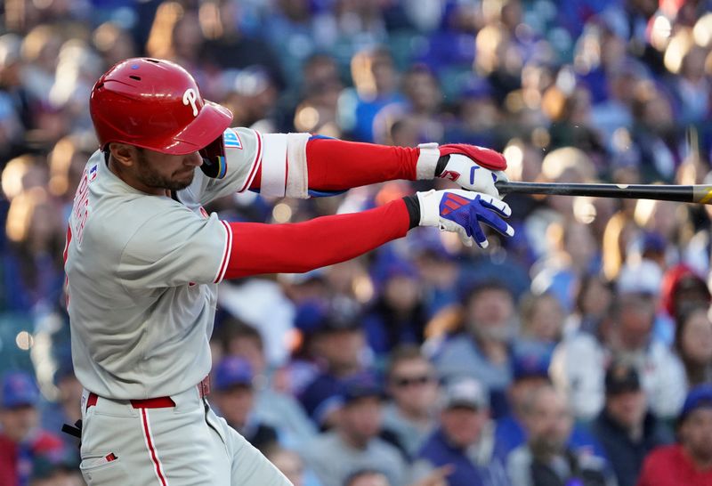 Apr 27, 2025; Chicago, Illinois, USA; Philadelphia Phillies shortstop Trea Turner (7) hits a single against the Chicago Cubs during the first inning at Wrigley Field. Mandatory Credit: David Banks-Imagn Images