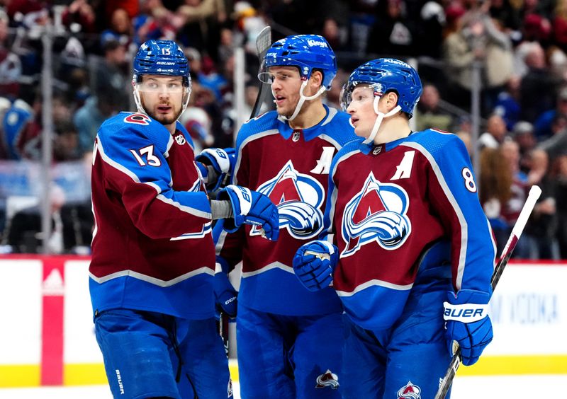 Nov 27, 2023; Denver, Colorado, USA; Colorado Avalanche defenseman Cale Makar (8) celebrates his goal with right wing Mikko Rantanen (96) and right wing Valeri Nichushkin (13) in the second period at Ball Arena. Mandatory Credit: Ron Chenoy-USA TODAY Sports