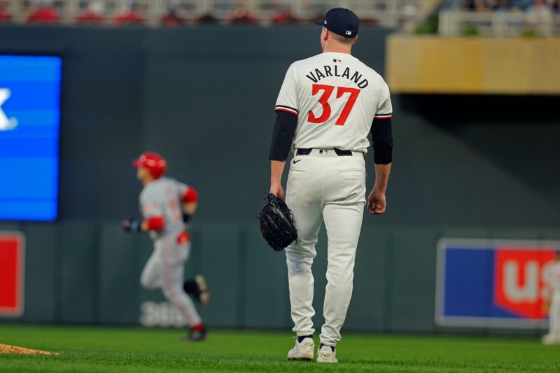 Sep 14, 2024; Minneapolis, Minnesota, USA; Cincinnati Reds center fielder TJ Friedl (29) runs the bases after hitting a two run home run as Minnesota Twins relief pitcher Louie Varland (37) watches in the fourth inning at Target Field. Mandatory Credit: Bruce Kluckhohn-Imagn Images