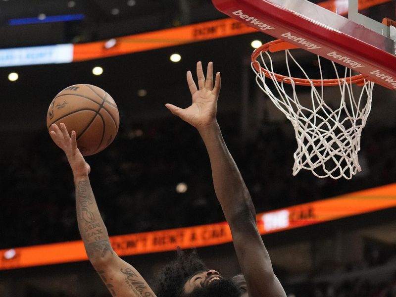 CHICAGO, ILLINOIS - APRIL 01: Coby White #0 of the Chicago Bulls shoots the ball against Clint Capela #15 of the Atlanta Hawks during the second half at the United Center on April 01, 2024 in Chicago, Illinois. NOTE TO USER: User expressly acknowledges and agrees that, by downloading and or using this photograph, User is consenting to the terms and conditions of the Getty Images License Agreement. (Photo by Patrick McDermott/Getty Images)