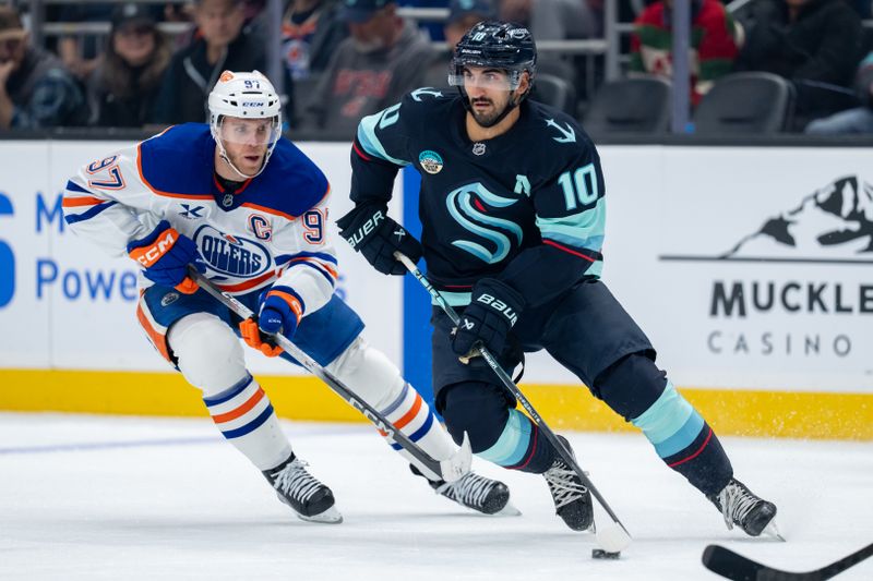 Oct 25, 2025; Seattle, Washington, USA; Seattle Kraken forward Matty Beniers (10) skates against Edmonton Oilers forward Connor McDavid (97) during the second period at Climate Pledge Arena. Mandatory Credit: Stephen Brashear-Imagn Images