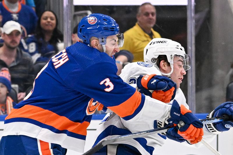 Feb 8, 2024; Elmont, New York, USA; New York Islanders defenseman Adam Pelech (3) checks Tampa Bay Lightning center Brayden Point (21) during the first period at UBS Arena. Mandatory Credit: Dennis Schneidler-USA TODAY Sports