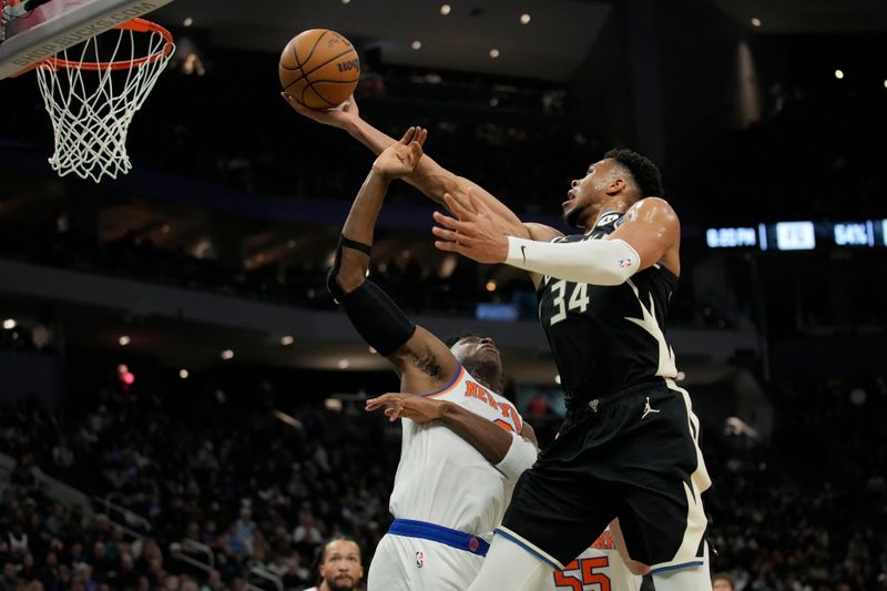 MILWAUKEE, WISCONSIN - APRIL 07: Giannis Antetokounmpo #34 of the Milwaukee Bucks shoots the ball against OG Anunoby #8 of the New York Knicks during the first half at Fiserv Forum on April 07, 2024 in Milwaukee, Wisconsin. NOTE TO USER: User expressly acknowledges and agrees that, by downloading and or using this photograph, User is consenting to the terms and conditions of the Getty Images License Agreement. (Photo by Patrick McDermott/Getty Images)