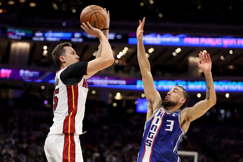 SACRAMENTO, CALIFORNIA - FEBRUARY 26: Duncan Robinson #55 of the Miami Heat shoots over Chris Duarte #3 of the Sacramento Kings in the second half at Golden 1 Center on February 26, 2024 in Sacramento, California. NOTE TO USER: User expressly acknowledges and agrees that, by downloading and or using this photograph, User is consenting to the terms and conditions of the Getty Images License Agreement.  (Photo by Ezra Shaw/Getty Images)